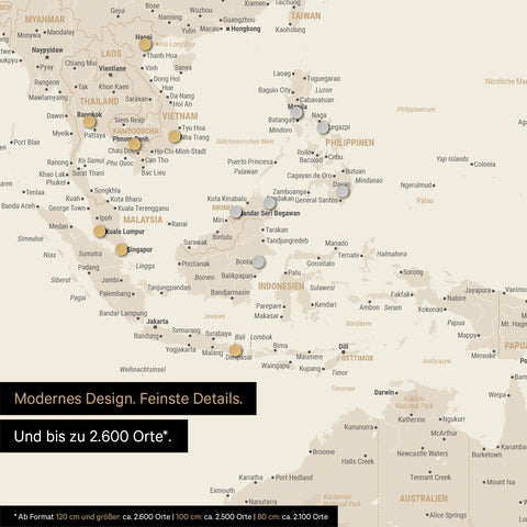 Ausschnitt einer magnetischen Weltkarte in Gold zeigt Karte von Asien, auf der Magnete Reiseziele markieren